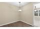 Cozy dining area featuring wood-look flooring and a modern light fixture, adjacent to another room at 101 Atchison St, Garner, NC 27529