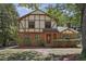 Charming Tudor-style home with brick facade, trimmed hedges, and beautiful landscaping at 101 Atchison St, Garner, NC 27529