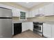 Efficient kitchen with white cabinets and stainless steel appliances at 101 Atchison St, Garner, NC 27529
