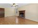 Comfortable living room with hardwood flooring, brick fireplace, and a ceiling fan for air circulation at 101 Atchison St, Garner, NC 27529
