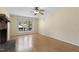 Inviting living room featuring hardwood floors, a brick fireplace, and large windows for natural light at 101 Atchison St, Garner, NC 27529