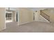 Bright living room featuring access to the staircase and rear patio at 101 Atchison St, Garner, NC 27529