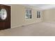 Bright, spacious living room with neutral carpet and large windows at 101 Atchison St, Garner, NC 27529