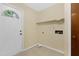 Mud room with white door, tile flooring, and open utilities connections for washer and dryer at 101 Atchison St, Garner, NC 27529