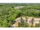 New construction homes surrounded by lush greenery and trees in a suburban neighborhood setting at 1013 Forrestal Pl, Durham, NC 27707