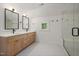 Bathroom featuring double sink vanity, mirrors and walk-in glass shower at 1013 Forrestal Pl, Durham, NC 27707