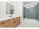 Bathroom features a modern vanity, framed mirror and tiled shower at 1013 Forrestal Pl, Durham, NC 27707