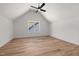 Bright bedroom features hardwood floors, a modern ceiling fan, and a window with a view at 1013 Forrestal Pl, Durham, NC 27707
