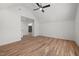 Bright bedroom boasts hardwood floors, a modern ceiling fan, and an open doorway to another room at 1013 Forrestal Pl, Durham, NC 27707