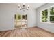 Open dining room with sliding glass doors to screened porch and natural wood floors at 1013 Forrestal Pl, Durham, NC 27707