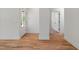 Open entryway featuring gleaming hardwood floors, white walls, and a glass-paneled front door at 1013 Forrestal Pl, Durham, NC 27707