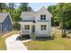 Charming two-story farmhouse with white siding, green front door, and a inviting front porch at 1013 Forrestal Pl, Durham, NC 27707