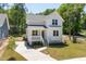 Beautiful two-story home with white siding, well-manicured lawn, and concrete driveway at 1013 Forrestal Pl, Durham, NC 27707