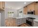 Kitchen features stainless appliances, custom cabinets, quartz counters and hardwood floors at 1013 Forrestal Pl, Durham, NC 27707