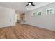 Open-concept living area with hardwood floors, white walls, and view into kitchen at 1013 Forrestal Pl, Durham, NC 27707
