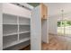 Walk-in pantry with built-in shelving and natural wood floors at 1013 Forrestal Pl, Durham, NC 27707