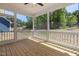 Screened-in porch featuring a wood floor and views of the home's exterior at 1013 Forrestal Pl, Durham, NC 27707