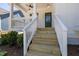 Close-up of front porch stairs, showing white railings and a green front door at 1013 Forrestal Pl, Durham, NC 27707