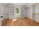 Large walk-in closet features hardwood floors, window and built-in shelves at 1013 Forrestal Pl, Durham, NC 27707