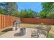 Backyard with a grill, patio furniture, a fire pit, privacy fence and green trees at 1021 Sweet Cream Ct, Durham, NC 27703