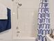 Shower and bathtub combination featuring blue patterned shower curtain and modern shower head at 1021 Sweet Cream Ct, Durham, NC 27703