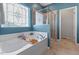Bright bathroom boasting soaking tub, separate shower, and decorative window at 1021 Sweet Cream Ct, Durham, NC 27703