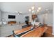 Open-concept dining area with a unique wooden table, flowing into the living room and kitchen for easy entertaining at 1021 Sweet Cream Ct, Durham, NC 27703