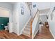Entryway view with staircase and half-bath showcasing elegant trim and lighting at 1021 Sweet Cream Ct, Durham, NC 27703