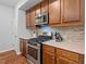 Modern kitchen featuring stainless steel appliances, stylish backsplash, and ample cabinet space for storage at 1021 Sweet Cream Ct, Durham, NC 27703