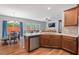 Kitchen view featuring stainless appliances and a dining area with ample natural light at 1021 Sweet Cream Ct, Durham, NC 27703