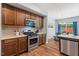 Well-equipped kitchen with stainless steel appliances, wood cabinetry, and seamless view into the adjacent dining area at 1021 Sweet Cream Ct, Durham, NC 27703
