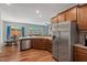 Open kitchen boasts stainless steel appliances, wood floors, and a seamless flow to the living and dining areas at 1021 Sweet Cream Ct, Durham, NC 27703