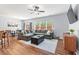 Spacious living room featuring a large sectional sofa, hardwood floors, and natural light at 1021 Sweet Cream Ct, Durham, NC 27703