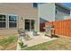 A cozy backyard patio has a grill and seating, great for outdoor living and entertaining near sliding glass door at 1021 Sweet Cream Ct, Durham, NC 27703