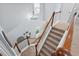 Carpeted staircase with wooden railing, providing a warm welcome and leading to the upper levels of the home at 1021 Sweet Cream Ct, Durham, NC 27703