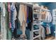 View of the walk-in closet that features built-in shelving and rods for ample storage at 1021 Sweet Cream Ct, Durham, NC 27703