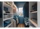 Spacious walk-in closet with built-in shelving, rods, and natural light from a window at 1021 Sweet Cream Ct, Durham, NC 27703