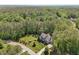 Stunning aerial view of a home with a sprawling lawn surrounded by lush trees and greenery at 1037 Lila Ln, Raleigh, NC 27614