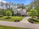 Aerial view of a beautiful home with manicured lawn and mature trees at 1037 Lila Ln, Raleigh, NC 27614