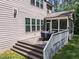 The back porch features seating for eight, stairs to the yard, and an overhead fan for relaxation and comfort at 1037 Lila Ln, Raleigh, NC 27614