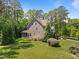 Backyard view shows the home's exterior with a screened in porch and large grassy area at 1037 Lila Ln, Raleigh, NC 27614