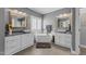 This spacious bathroom features a soaking tub, double sink vanity, wood-framed mirrors, and neutral paint at 1037 Lila Ln, Raleigh, NC 27614