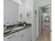 Well-lit bathroom featuring a granite countertop, modern fixtures, and tasteful botanical prints at 1037 Lila Ln, Raleigh, NC 27614