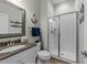 Well-lit bathroom with granite countertop vanity and walk-in shower at 1037 Lila Ln, Raleigh, NC 27614