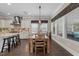 Bright dining area with a wooden table, large windows, and modern lighting, ideal for gatherings at 1037 Lila Ln, Raleigh, NC 27614