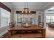 Dining room featuring a wooden table, bench seating, and large window providing natural light at 1037 Lila Ln, Raleigh, NC 27614