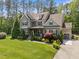 Well-manicured lawn surrounds this home with detailed architectural features and an attached garage at 1037 Lila Ln, Raleigh, NC 27614