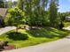 Lush front lawn and trees provide a serene setting and enhance curb appeal at 1037 Lila Ln, Raleigh, NC 27614