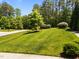 Well-maintained front yard featuring lush lawn, trees, and landscaping at 1037 Lila Ln, Raleigh, NC 27614