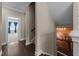 Hallway with hardwood floors and a view of a bedroom with blue curtains beyond at 1037 Lila Ln, Raleigh, NC 27614